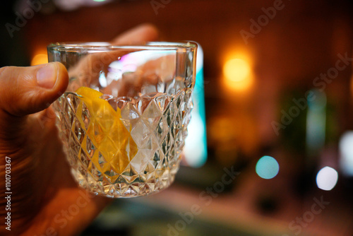 hand with short glass drink at event