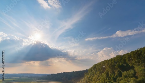 A serene sky bathed in sunlight, adorned with a rich blue hue, complemented by alternating small and large clouds, creating a harmonious natural landscape filled with peace and beauty.