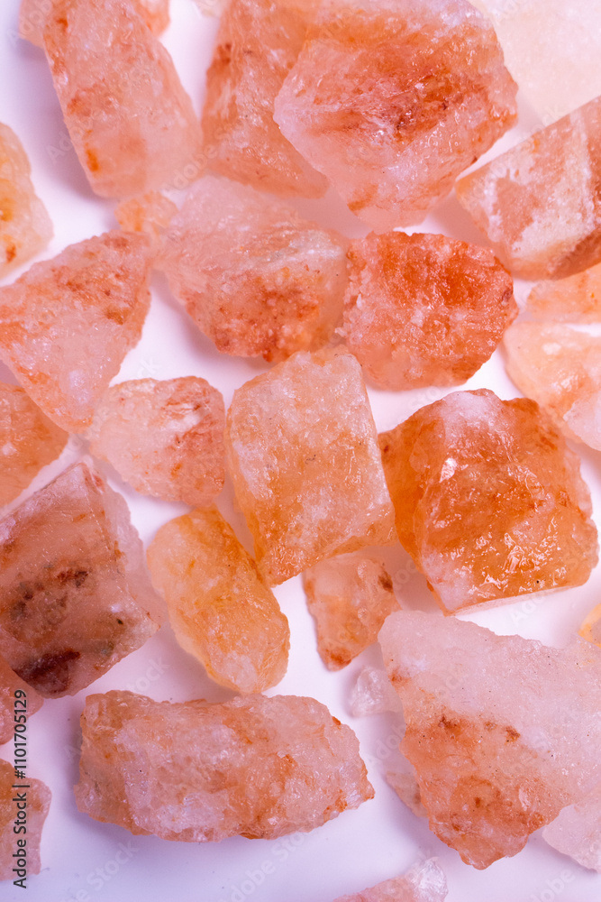 A pile of pink rocks on a white background. The rocks are of different sizes and shapes, and they appear to be arranged in a random pattern. A pile of pink rocks on a white background. The rocks are of different sizes and shapes, and they appear to be arranged in a random pattern.