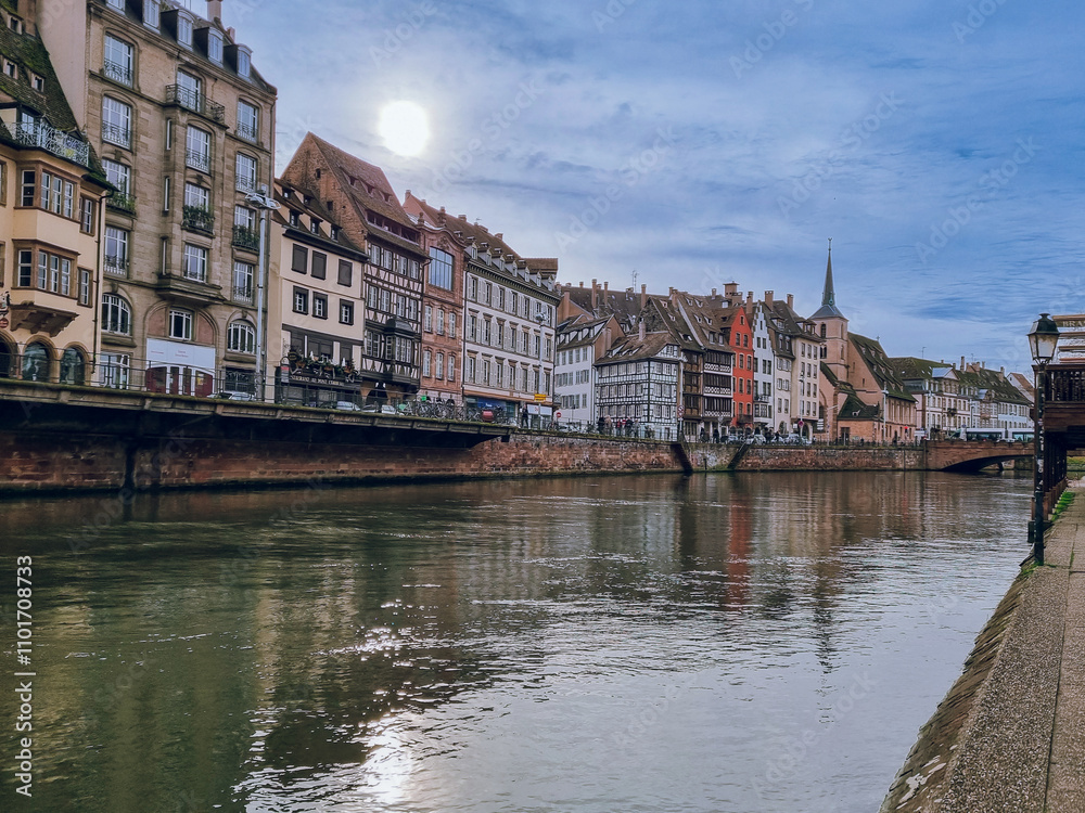 Fototapeta premium Strasbourg, Ill River canal with promenade and row of colorfultownhouses, France, Bas-Rhin,