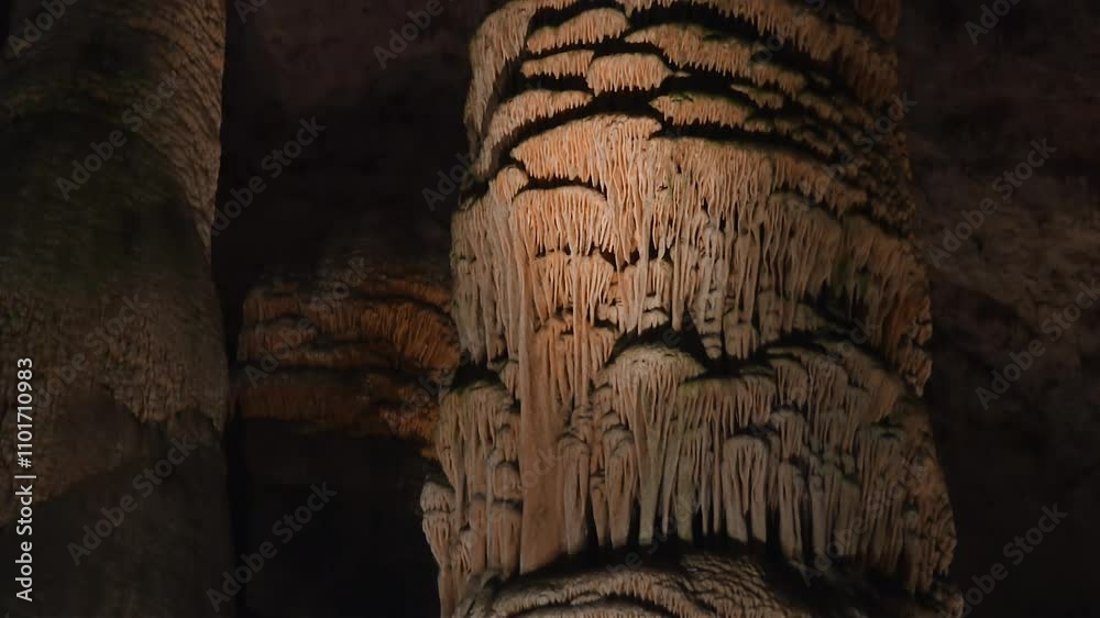 Close-up of stalactite formations inside Carlsbad Caverns, New Mexico. Tilt up ascending shot