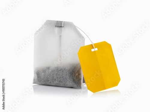 Teabag with yellow label. Isolated on white background