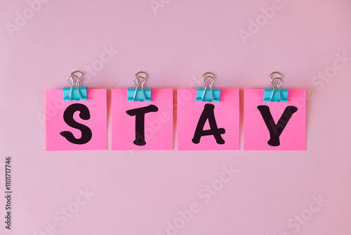 Stay text on a pink sticker and on pink background. photo