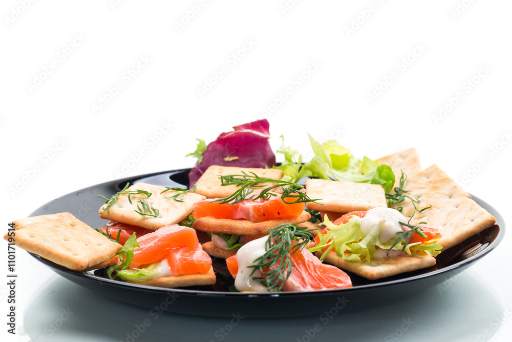 small snack canapes with crackers and lightly salted red fish Salmon, isolated on white background small snack canapes with crackers and lightly salted red fish Salmon, isolated on white background