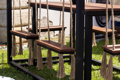 Seats are suspended on ropes around the table. Stylish