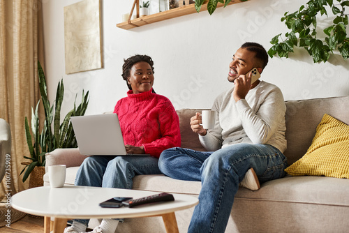 Εκτύπωση καμβά A happy couple enjoys quality time together in their cozy living room while staying warm