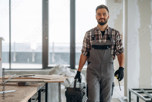 Box with instruments, tools. A man is renovating an unfinished room