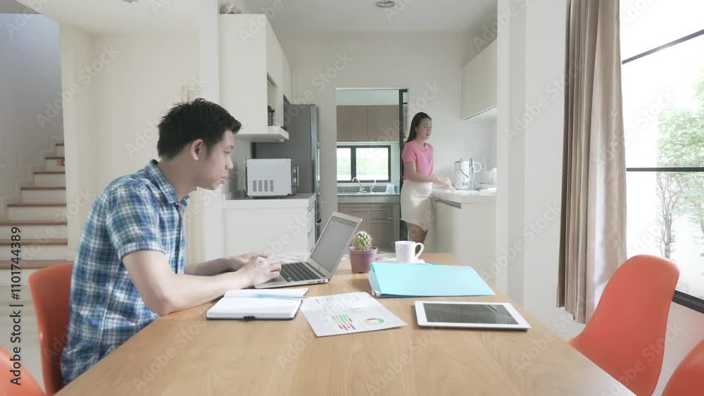A man and a woman are working together with laptops and cell phones. The man is looking at his phone while the woman is looking at her laptop. Scene is focused and serious A man and a woman are working together with laptops and cell phones. The man is looking at his phone while the woman is looking at her laptop. Scene is focused and serious