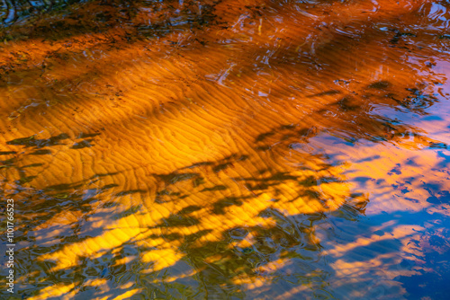 the water surface of a river or lake with sun glare at sunset