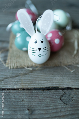 Easter bunny in front of Easter eggs