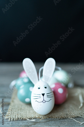 Easter bunny in front of Easter eggs