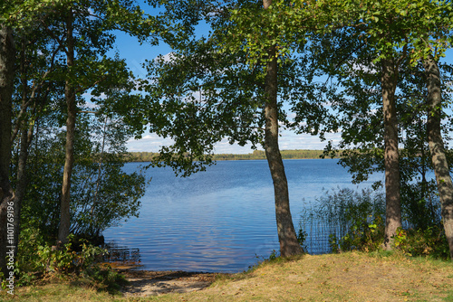 autumn landscape with river, road and clouds in the blue sky