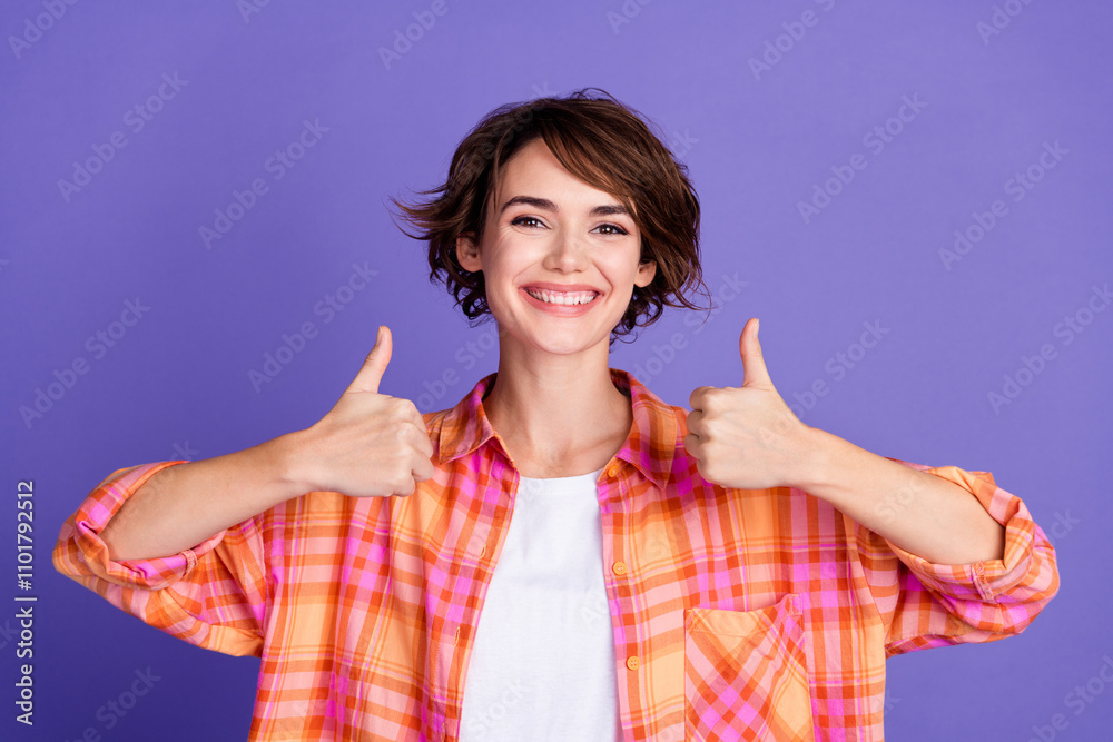 Photo of pretty young girl show thumb up wear shirt isolated on violet color background Photo of pretty young girl show thumb up wear shirt isolated on violet color background