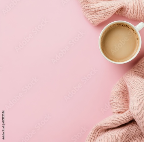 Warm coffee cup with soft pink blanket and delicate blossoms arranged artfully