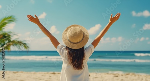 Woman enjoying the beach under a clear sky with arms raised in celebration