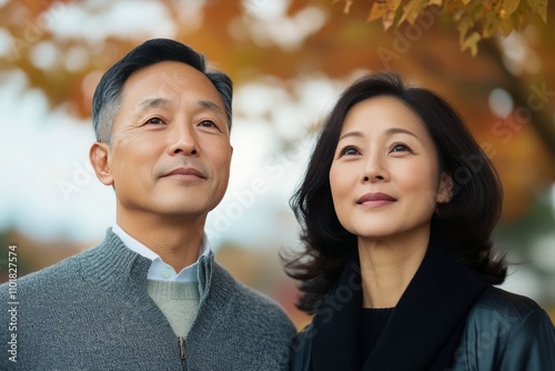 Couple enjoying a quiet moment in a natural setting during autumn season