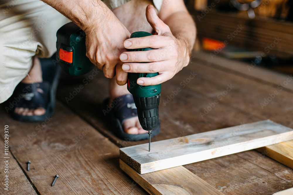 work with a screwdriver. sewing together wooden block with a screw work with a screwdriver. sewing together wooden block with a screw