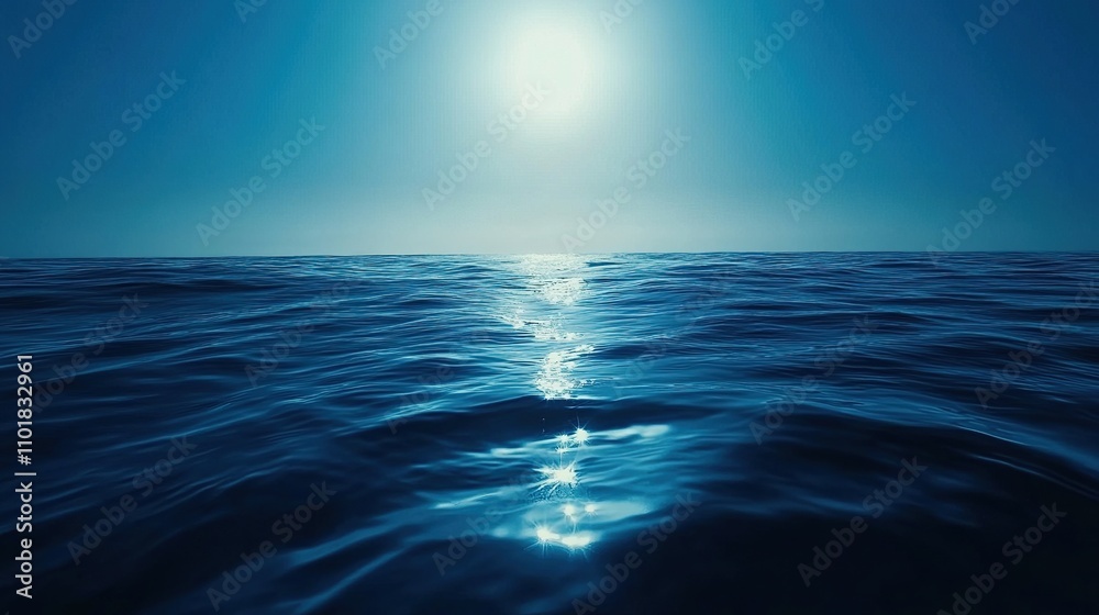 Obraz premium Serene Deep Blue Water with Reflections Beneath Bright Sky