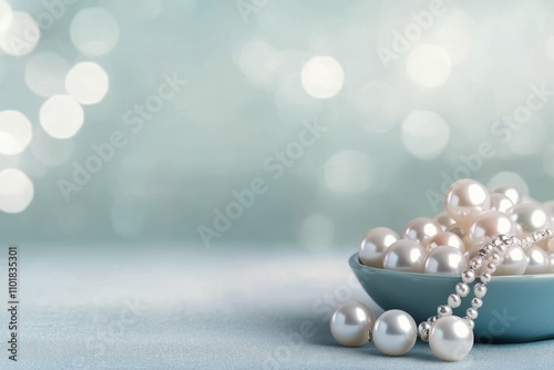 Elegant pearl necklace arranged on soft fabric with blurred background