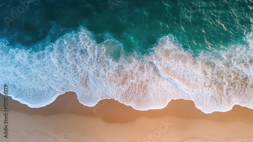 Aerial view of gentle waves lapping against a sandy beach, creating a serene atmosphere. Perfect for capturing the beauty of nature with ample photo style copy space.