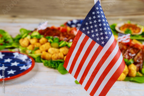 Vbrant display of festive foods includes American flag displayed prominently, celebrating Independence Day with classic treats and decorative elements. photo