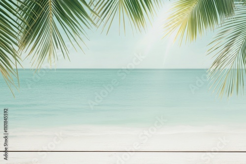 Tropical beach view with wooden deck and palm leaves under a clear blue sky a...