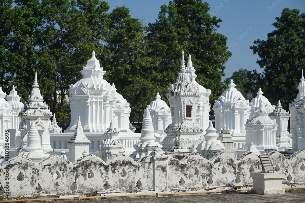 A cluster of white chedis, or Buddhist stupas, buddhist tomb, northern Thailand temple A cluster of white chedis, or Buddhist stupas, buddhist tomb, northern Thailand temple