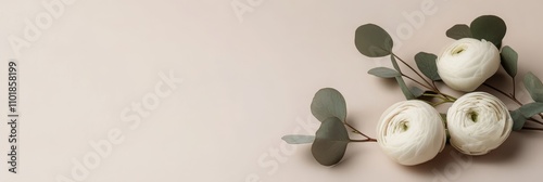 Beautiful arrangement of white flowers and greenery on a soft pastel backgrou...