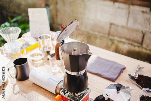 prepares coffee in a moka pot, carefully brewing on a stovetop in the cozy kitchen, timeless and flavorful coffee making ritual. horizontal photo photo