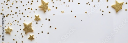 Decorative golden stars and glitter scattered on a white background for celeb...