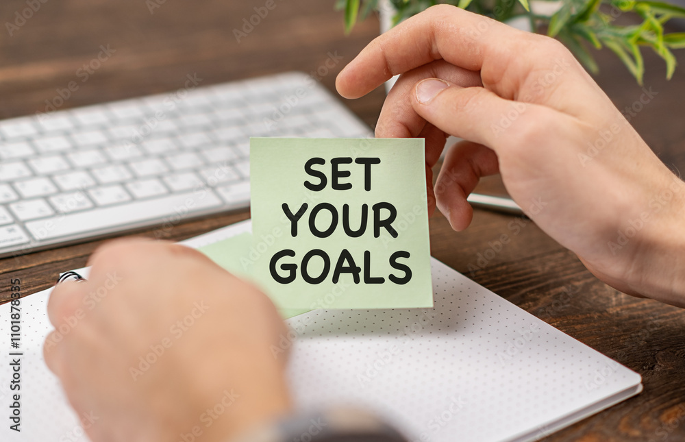 Business concept - Top view notebook writing Set Your Goals