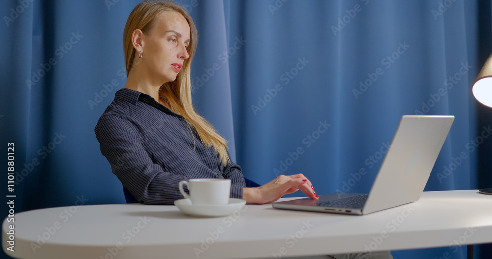 Woman Working on Laptop at Desk with Table Lamp Woman Working on Laptop at Desk with Table Lamp
