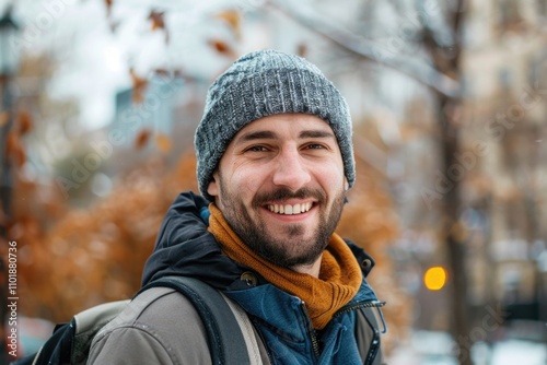 A smiling man wearing a hat and scarf, suitable for winter or outdoor scenes