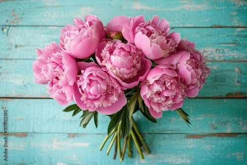 Fototapeta Naklejka Na Ścianę i Meble -  A bouquet of pink peonies arranged on a blue table