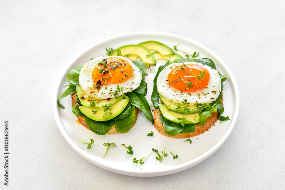 Fried eggs, avocado and greens on bread Fried eggs, avocado and greens on bread