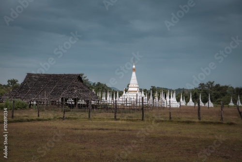 A white pagoda in the middle of a grass field , Kayin state Myanmar. photo