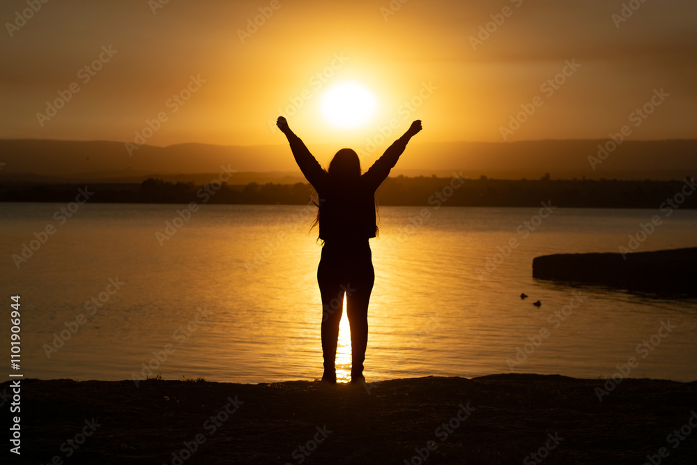silhouette of a girl raising her arms silhouette of a girl raising her arms