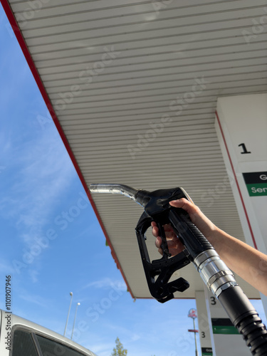 A person is filling up their car at a gas station