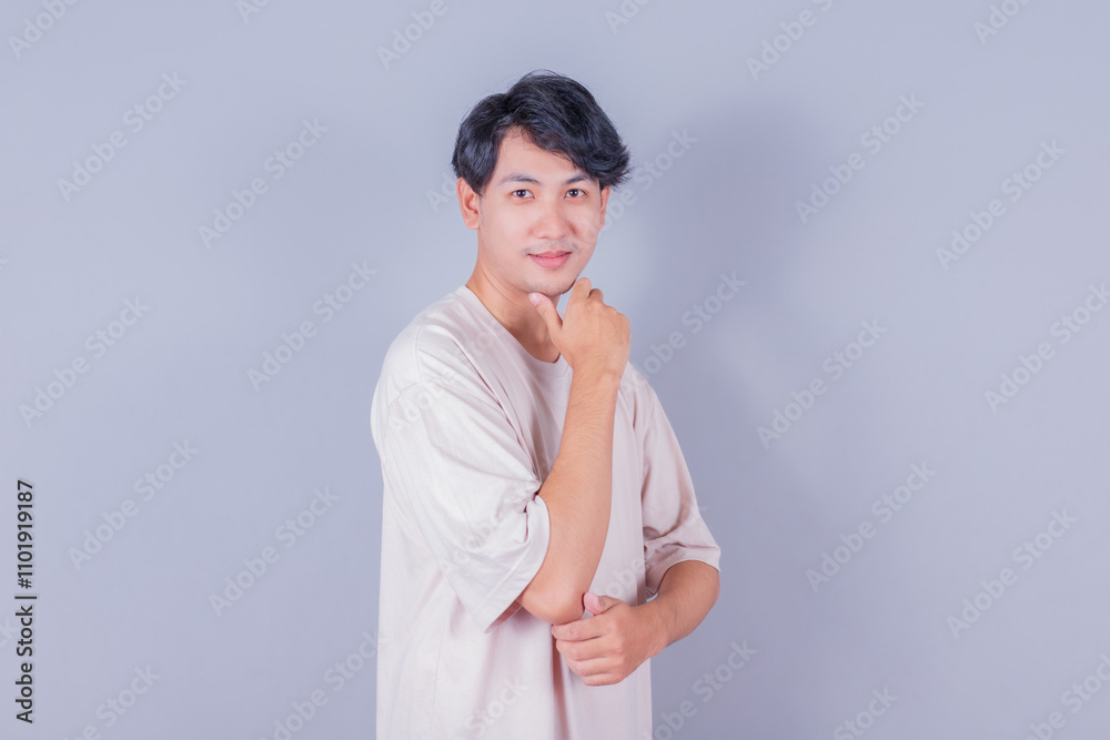 portrait of young handsome southeast Asian employee on gray background portrait of young handsome southeast Asian employee on gray background