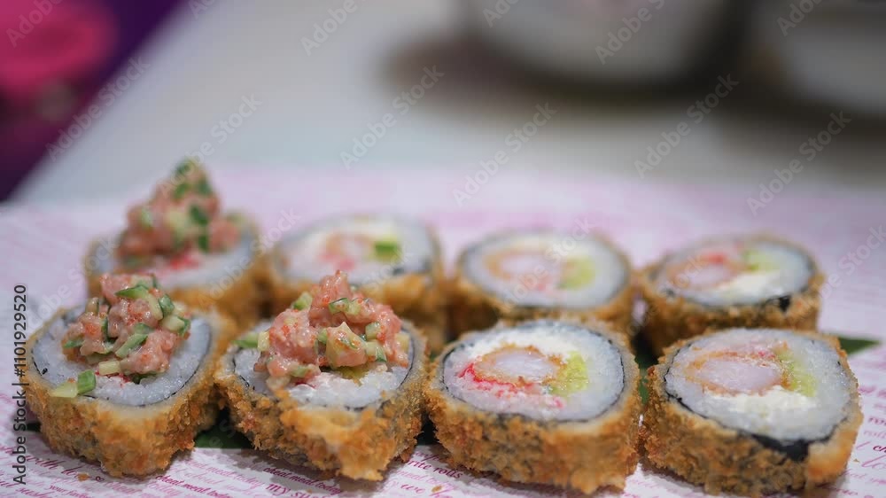 Fried sushi rolls topped with creamy filling, spoon adding garnish, crispy crust, vibrant colors, professional presentation, food preparation closeup Fried sushi rolls topped with creamy filling, spoon adding garnish, crispy crust, vibrant colors, professional presentation, food preparation closeup