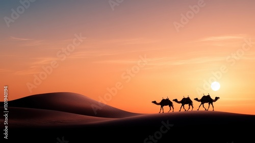A string of camels and riders walk across the gentle desert dunes  silhouetted against a vibrant dusk sky as the sun sets in the horizon.