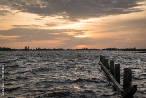 Sunset at Langweerder Wielen (Frisian: Langwarder Wielen), Frisian Lake in the Netherlands. View of the church tower of Langweer.  photo