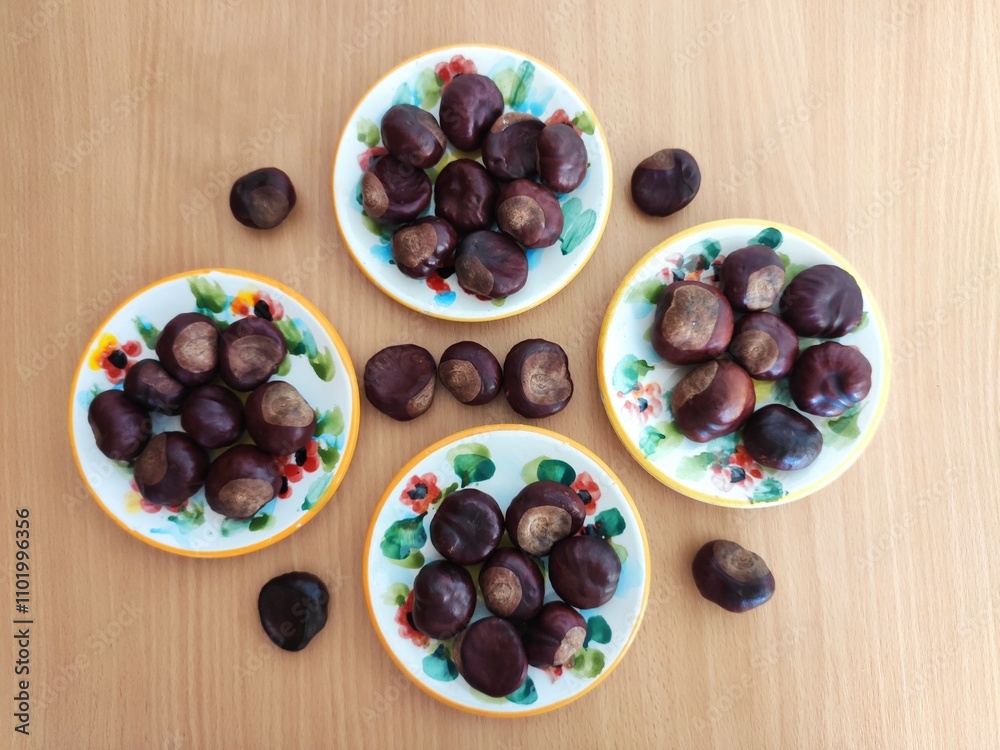 Yellow lemons and shiny brown chestnuts on the table Yellow lemons and shiny brown chestnuts on the table