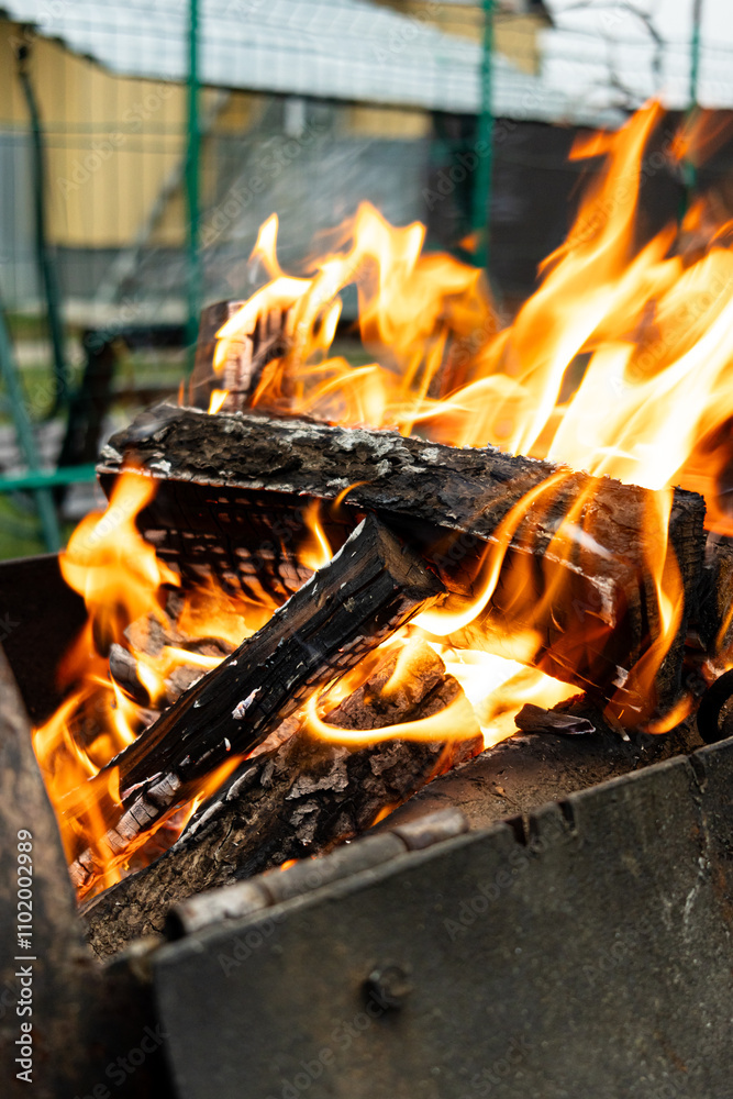 Burning wood. Flame fire sparks on dark abstract background. Cooking barbecue outdoor. Hellish fire element. Fuel, power and energy. Burning wood. Flame fire sparks on dark abstract background. Cooking barbecue outdoor. Hellish fire element. Fuel, power and energy.