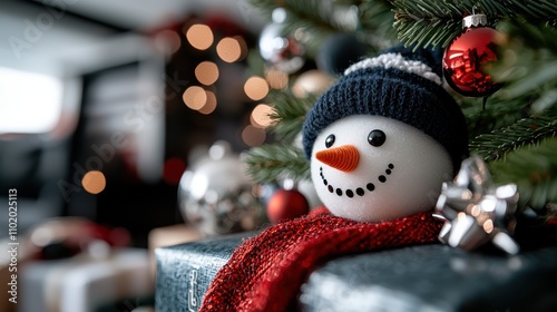 Adorned with a red scarf and knit hat, this snowman sits cheerfully amidst Christmas decorations, capturing the warmth and coziness of a holiday home. photo