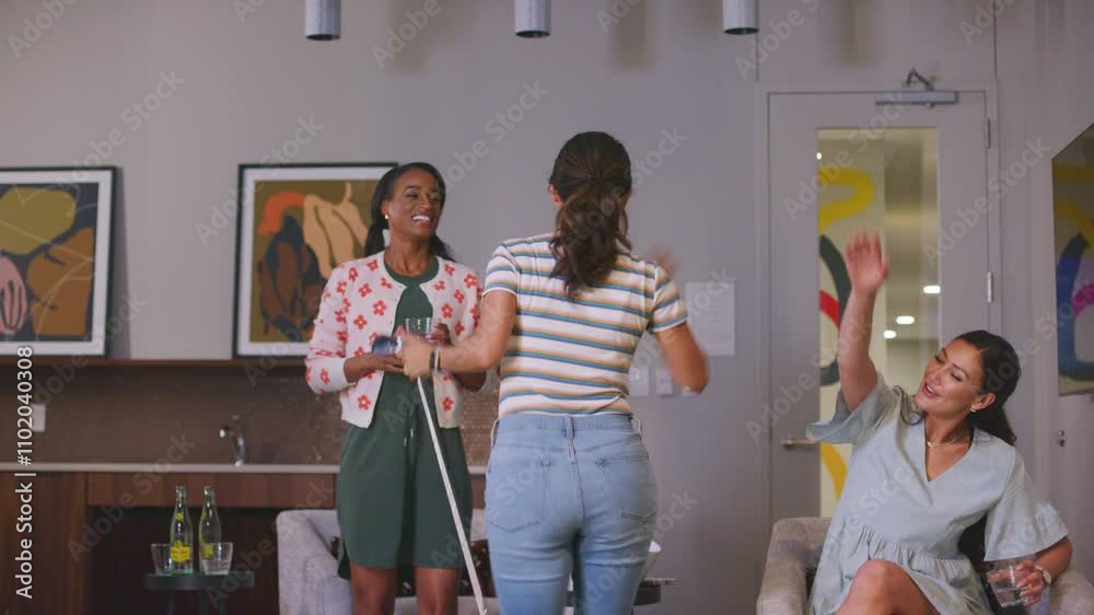 Woman cheers with friends after a winning swing on a golf simulator