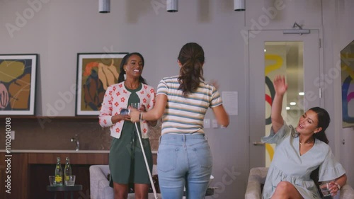 Wallpaper Mural Woman cheers with friends after a winning swing on a golf simulator Torontodigital.ca