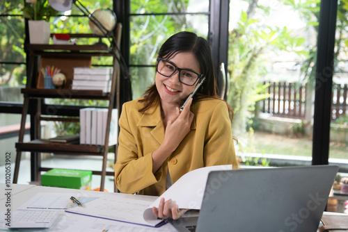 Businesswoman holding a phone talking about a housing development project