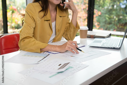 Businesswoman holding a phone talking about a housing development project