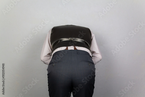 Vintage Gentleman in Waistcoat Bending Over. Backside of Gentleman Looking for Something.